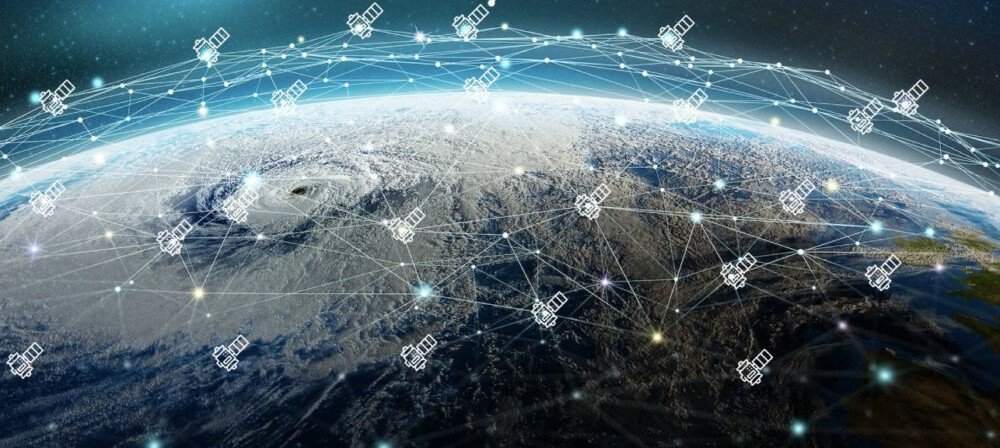 Mesh of communications satellites relaying data above the Earth